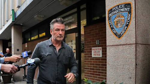 Actor Alec Baldwin leaving a New York City police department as reporters attempt to question him. [Formatted]